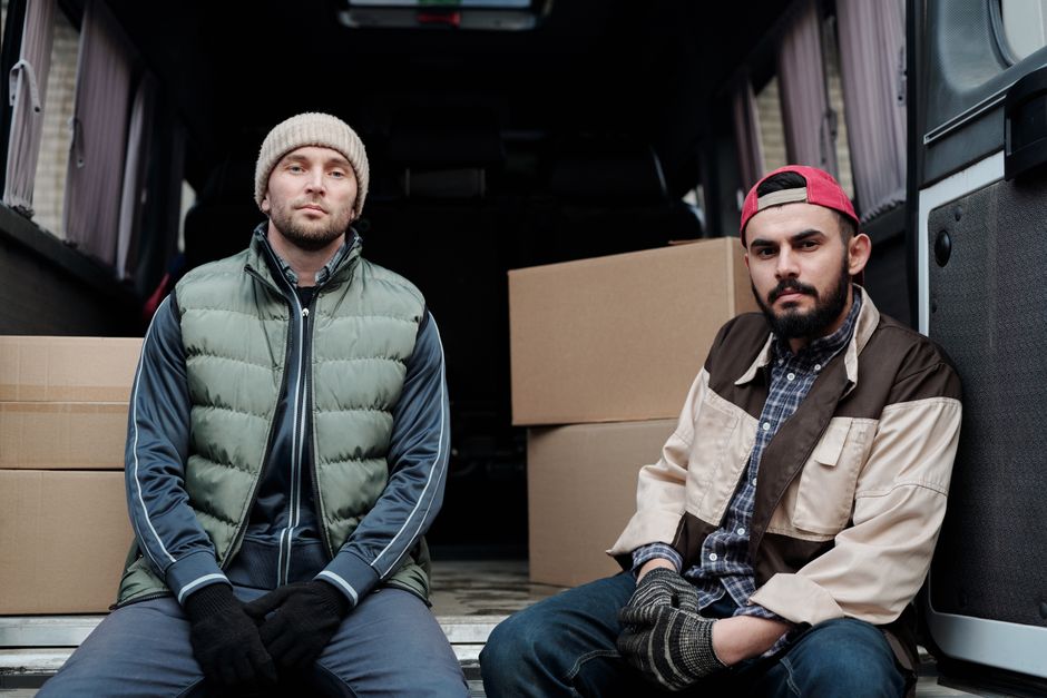 Team of professional movers standing together confidently