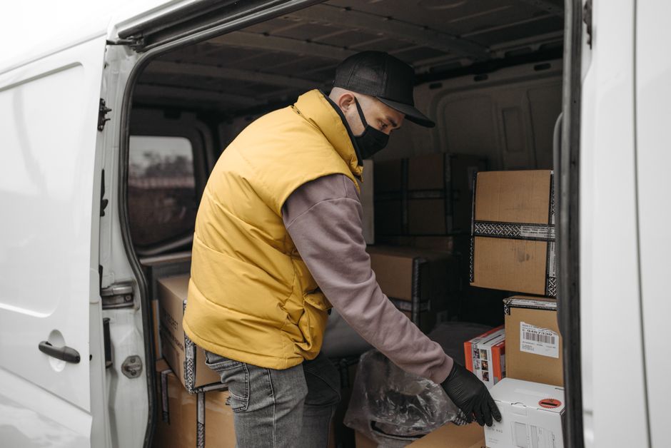 Movers unloading organized boxes from a moving truck